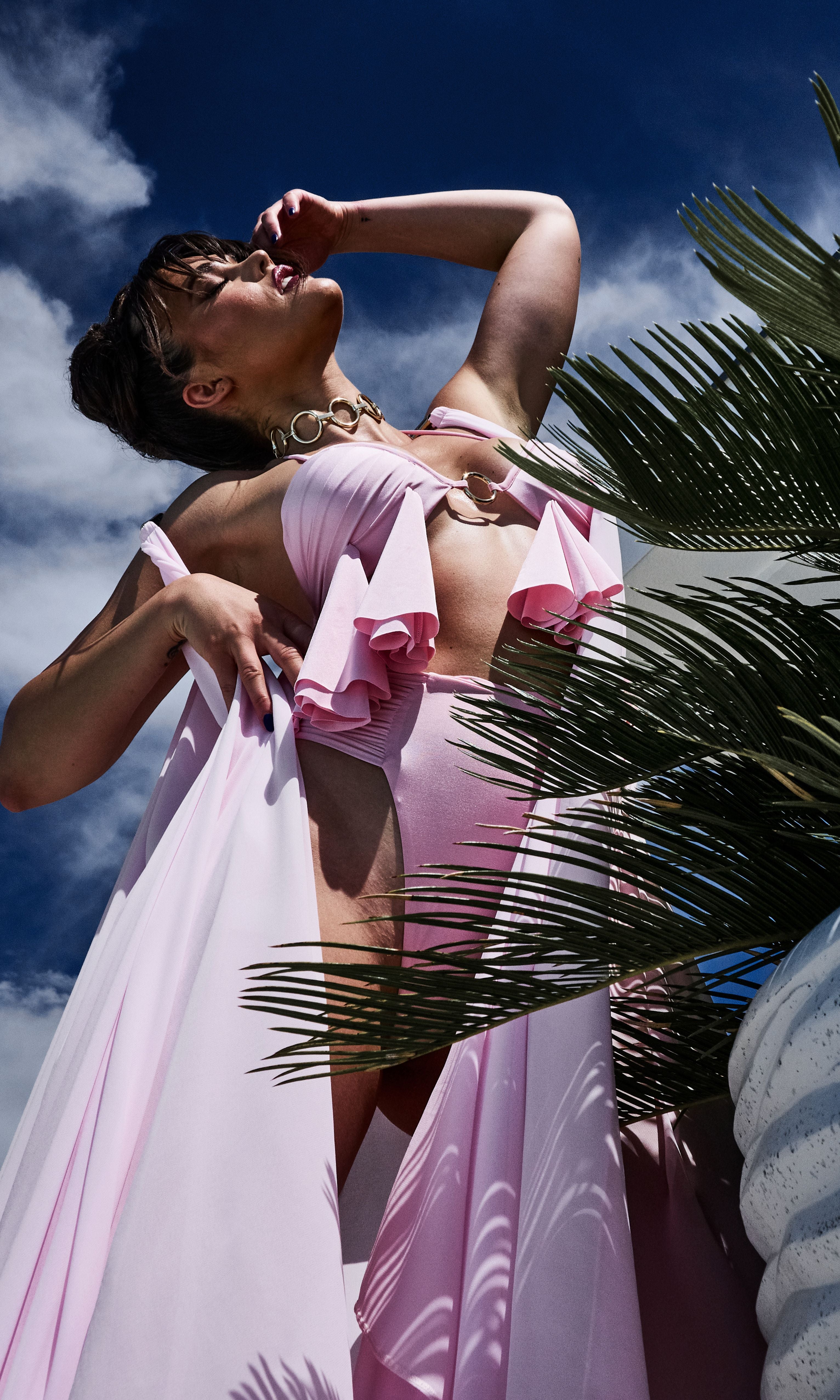 Antoninias Aurelia sustainable pink bikini top with flowy layered drapes and central gold ring, crafted for luxury beachwear and elegant resort fashion.