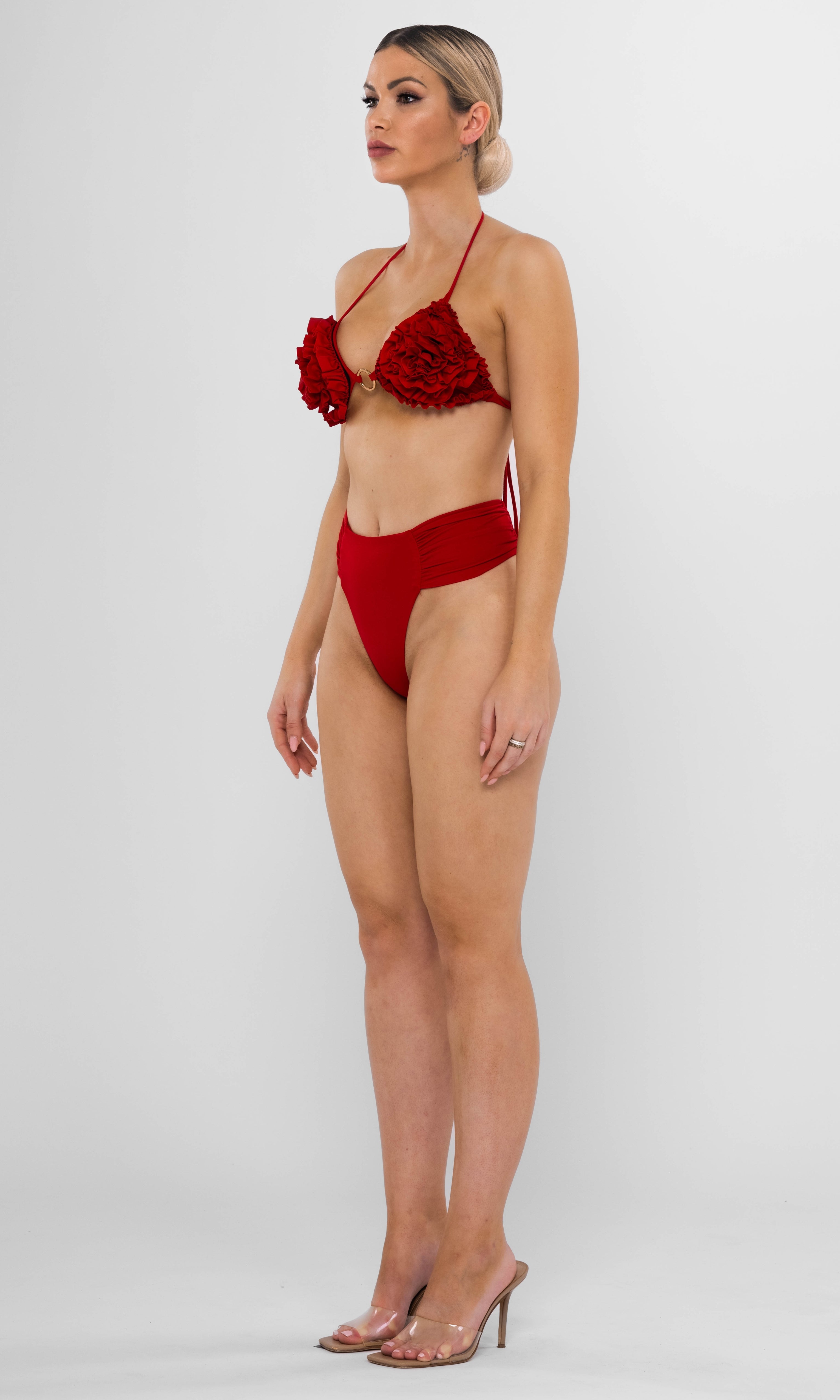 Luxury sustainable red bikini bottom by Antoninias from the Clam collection, featuring a high-cut silhouette with ruched side details, crafted for premium designer swimwear.