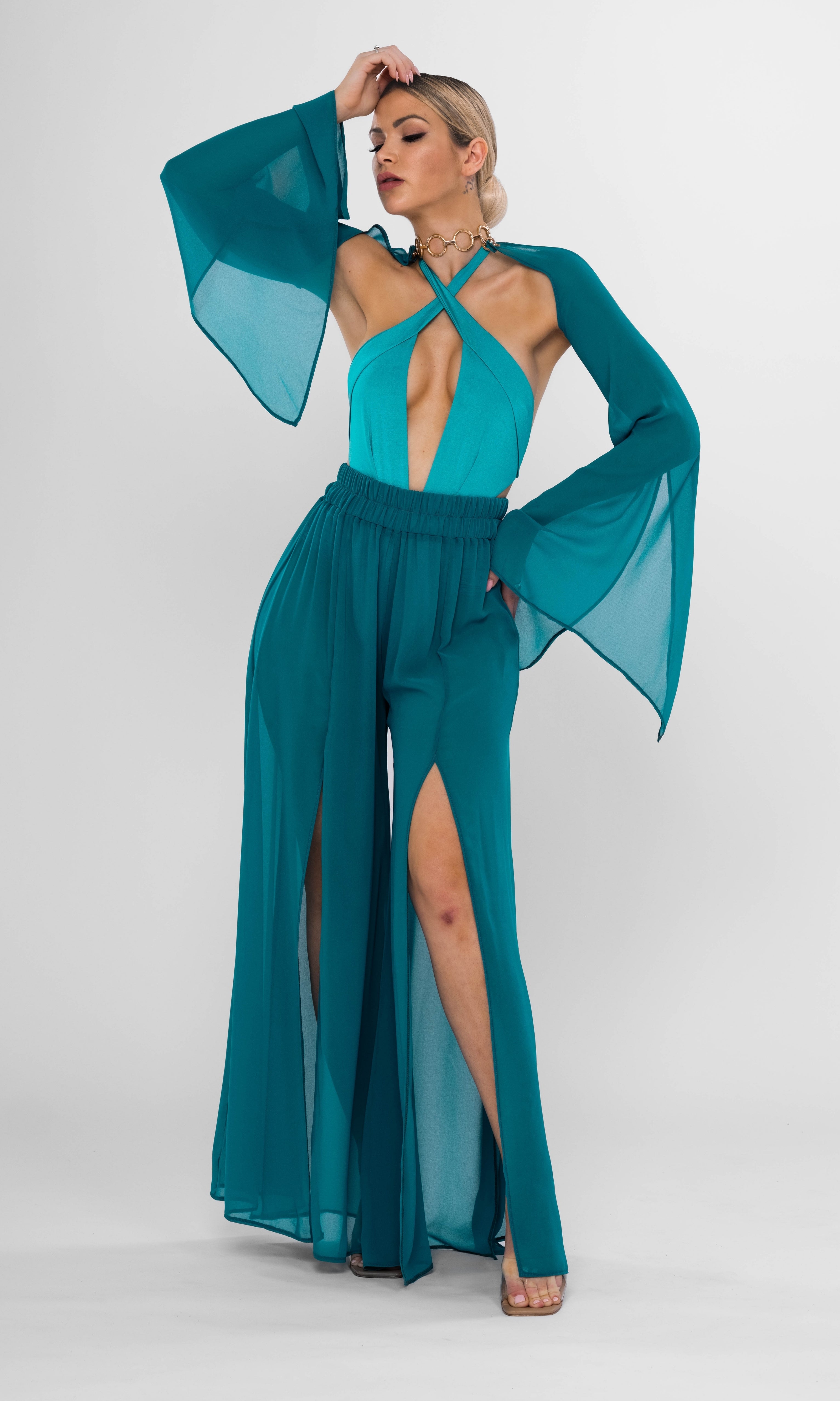 Luxury sustainable Elysia pants in petrol color by Antoninias, featuring a flowy wide-leg silhouette with dramatic slits, crafted for premium resort wear and sophisticated womenswear.