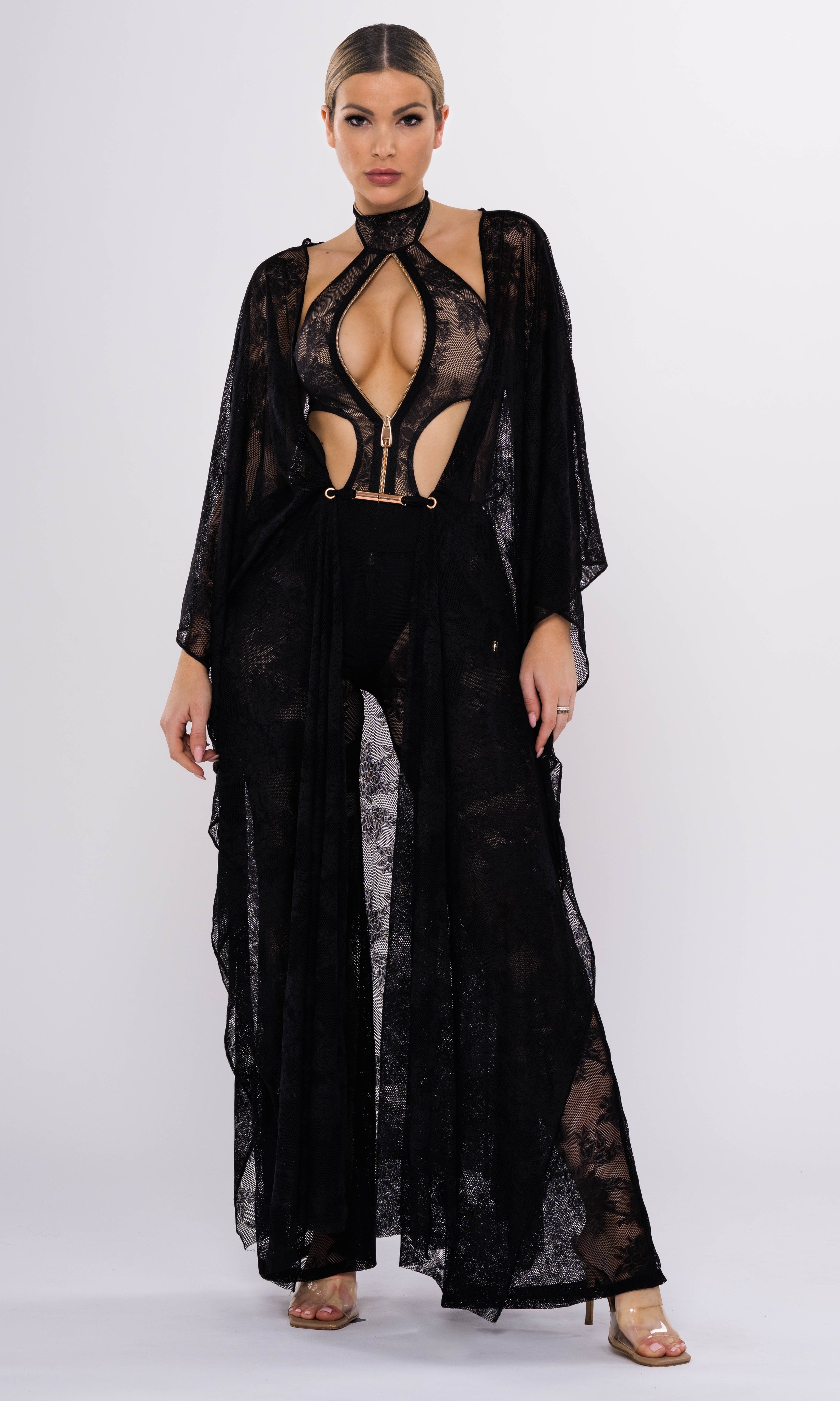 Model wearing Flora luxury sustainable one-piece swimsuit by Antoninias, featuring lace paneling, front zipper, and cut-out details, perfect for premium designer resort wear.