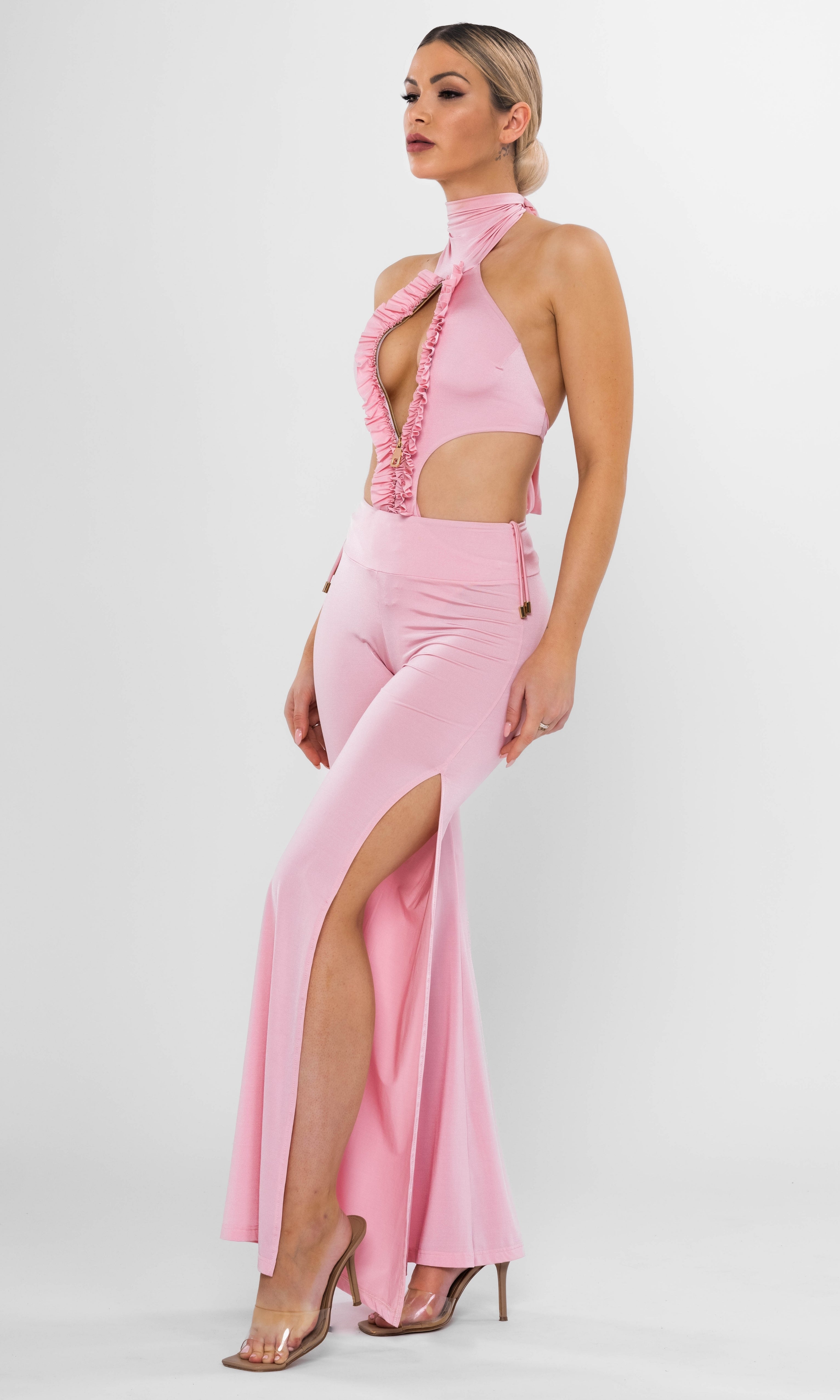 Luxury sustainable Spring one-piece swimsuit in pink by Antoninias, featuring ruffle detailing, bold cut-out sides, and a front zipper, crafted for premium resort wear and elegant designer swimwear.