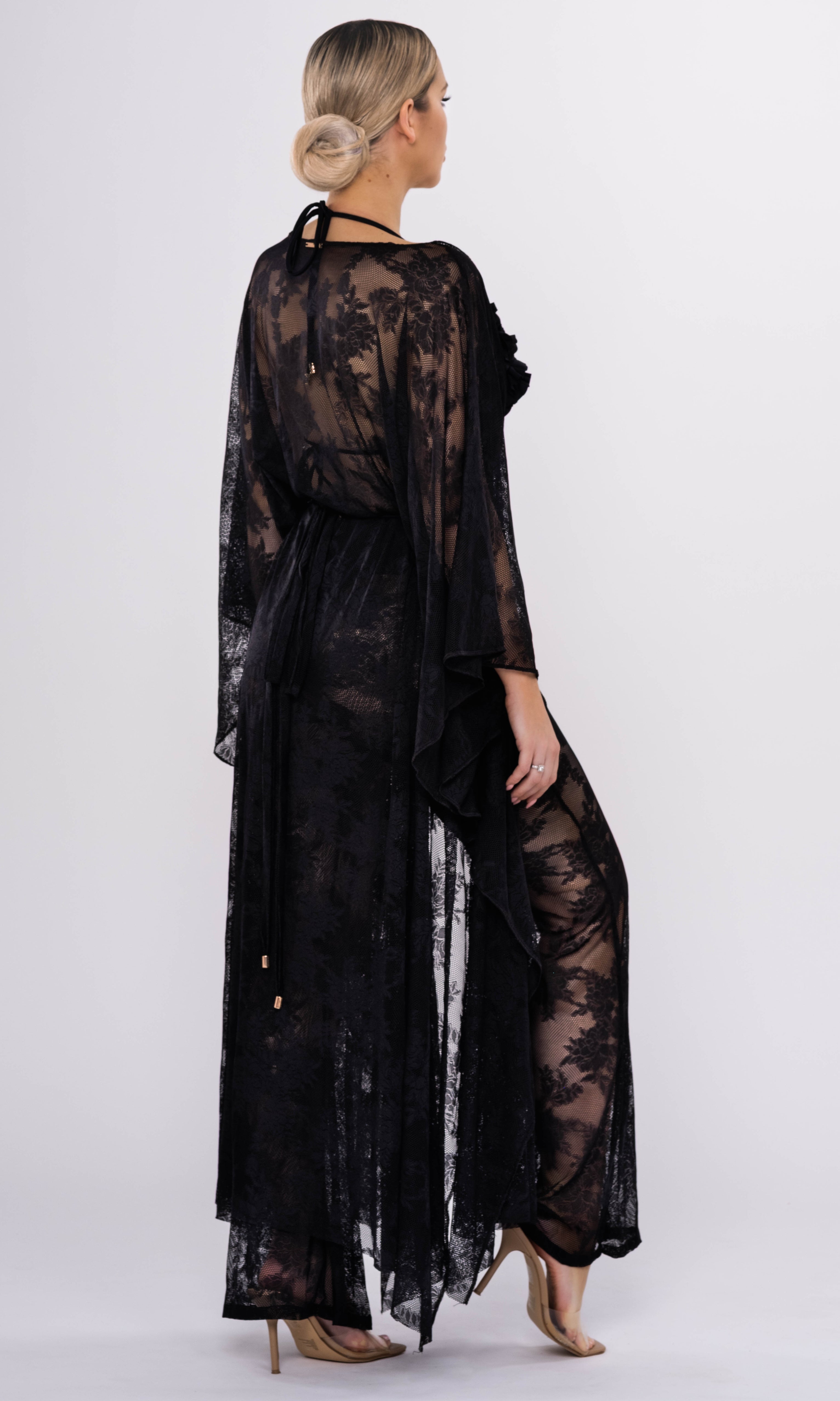 Luxury sustainable lace cover-up by Antoninias from the Flora collection, featuring sheer floral fabric, flowy silhouette, and a gold-tone belt, ideal for premium resort wear and designer womenswear.