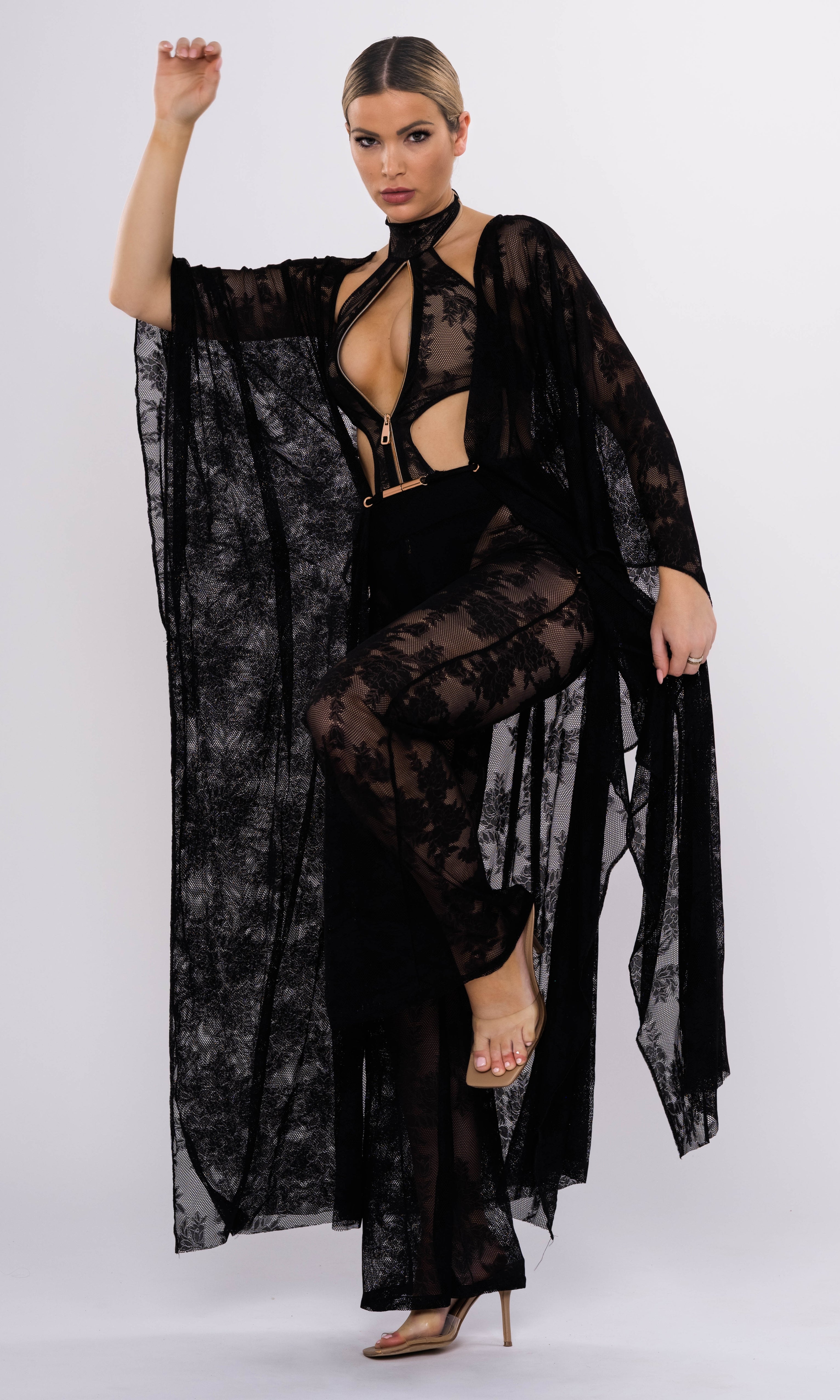 Model wearing Flora luxury sustainable one-piece swimsuit by Antoninias, featuring lace paneling, front zipper, and cut-out details, perfect for premium designer resort wear.